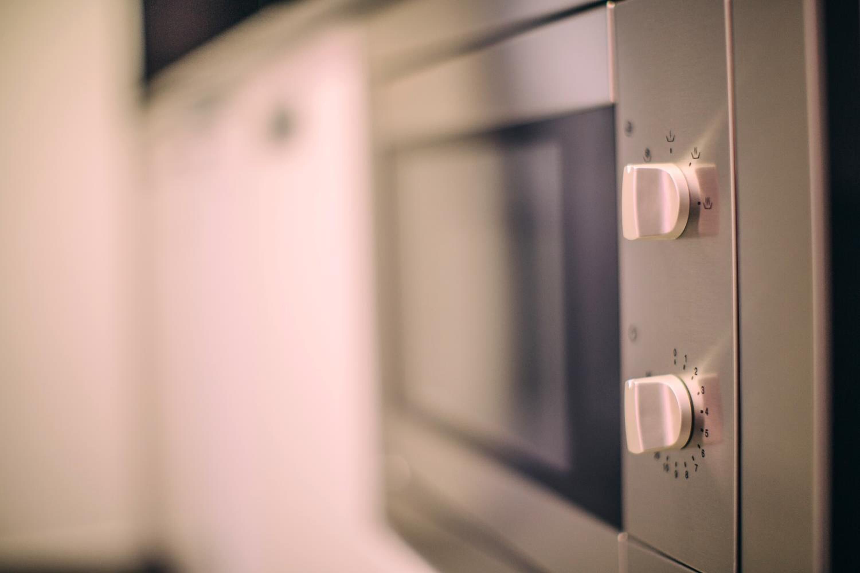 A close-up of a microwave oven with a control panel.