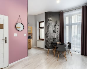 A modern kitchen with a microwave, wooden cabinets, and a window. - Z14 Boutique Residence - Krakow Old Town (Kraków)