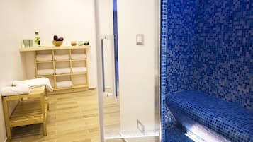 Experience a serene bathroom retreat with a clean bench, toiletries on a shelf, and a spacious shower area.