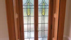 A wooden double door with frosted glass panels and a decorative design. - Inverleith Estate (Edinburgh)
