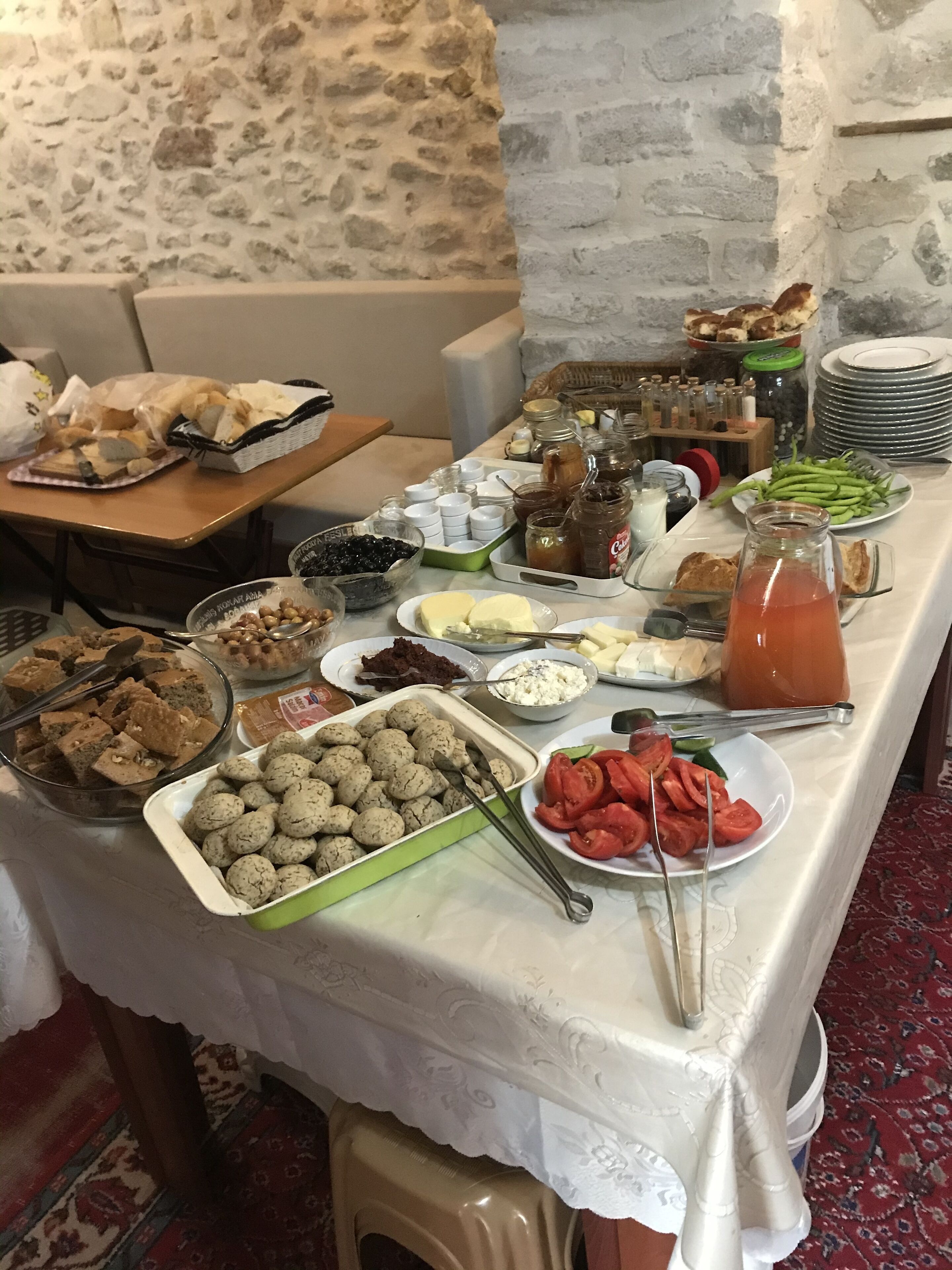 A buffet table with various food items and condiments.
