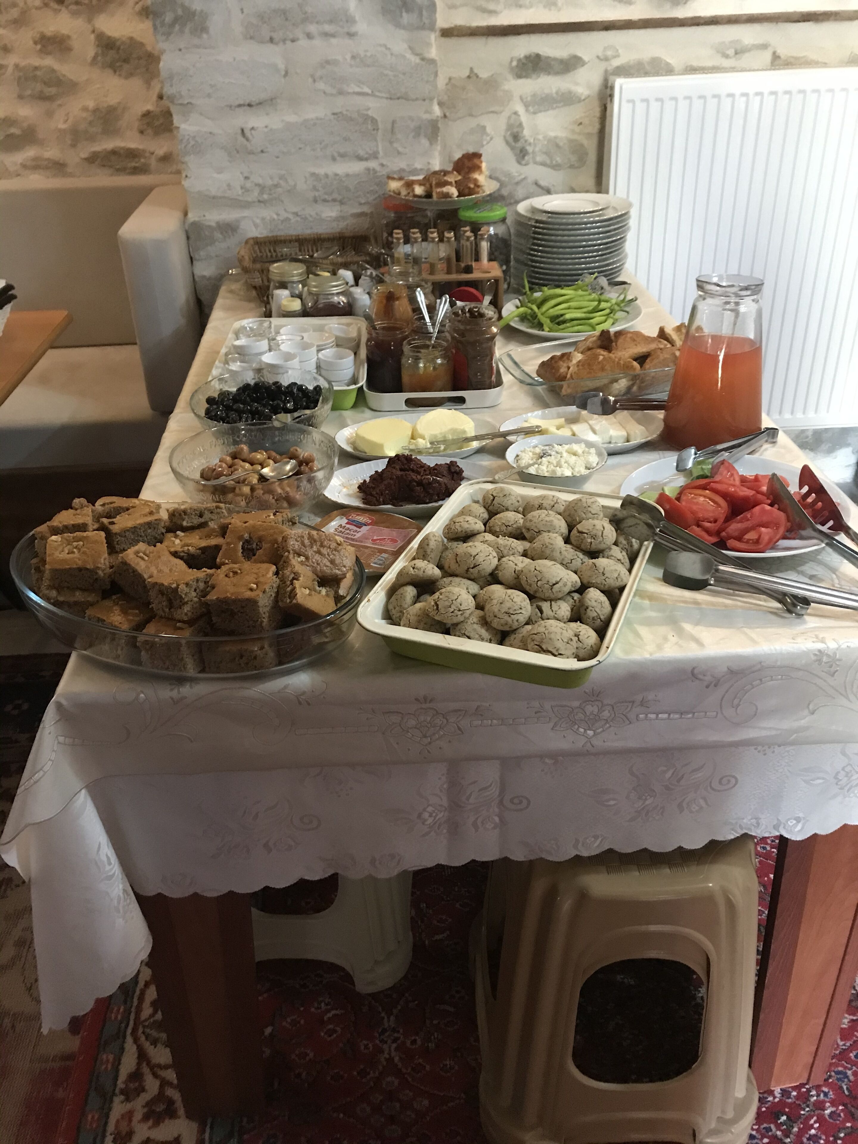A buffet table with various food items and condiments.