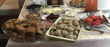 A buffet table with various food items and condiments.