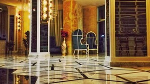 A spacious lobby with a polished marble floor, a grand chandelier, and a seating area with chairs. - Exelans Hotel (Fethiye)