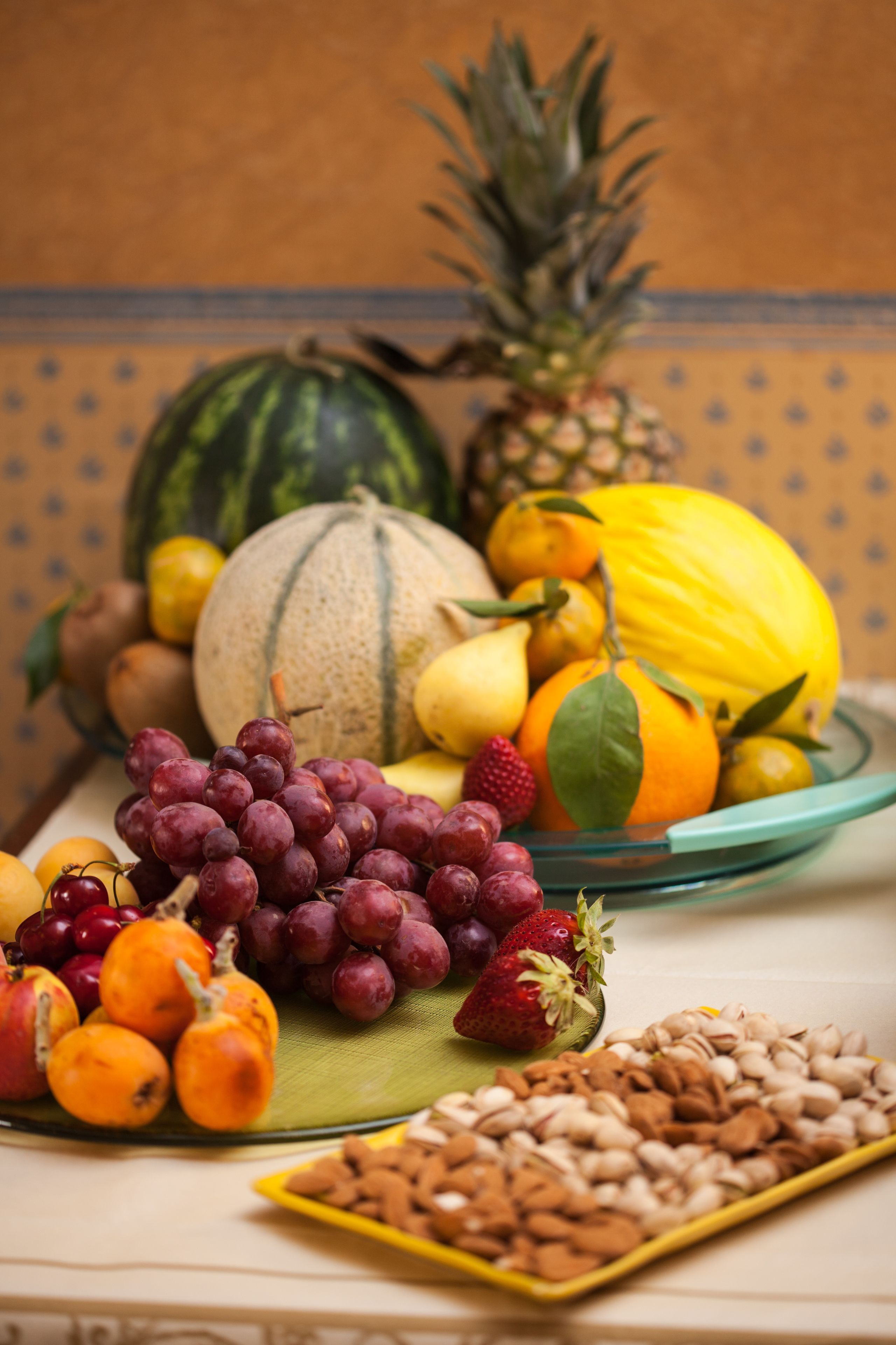 A variety of fruits and nuts on a table.
