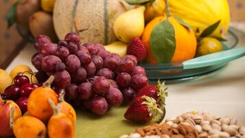 A variety of fruits and nuts on a table.