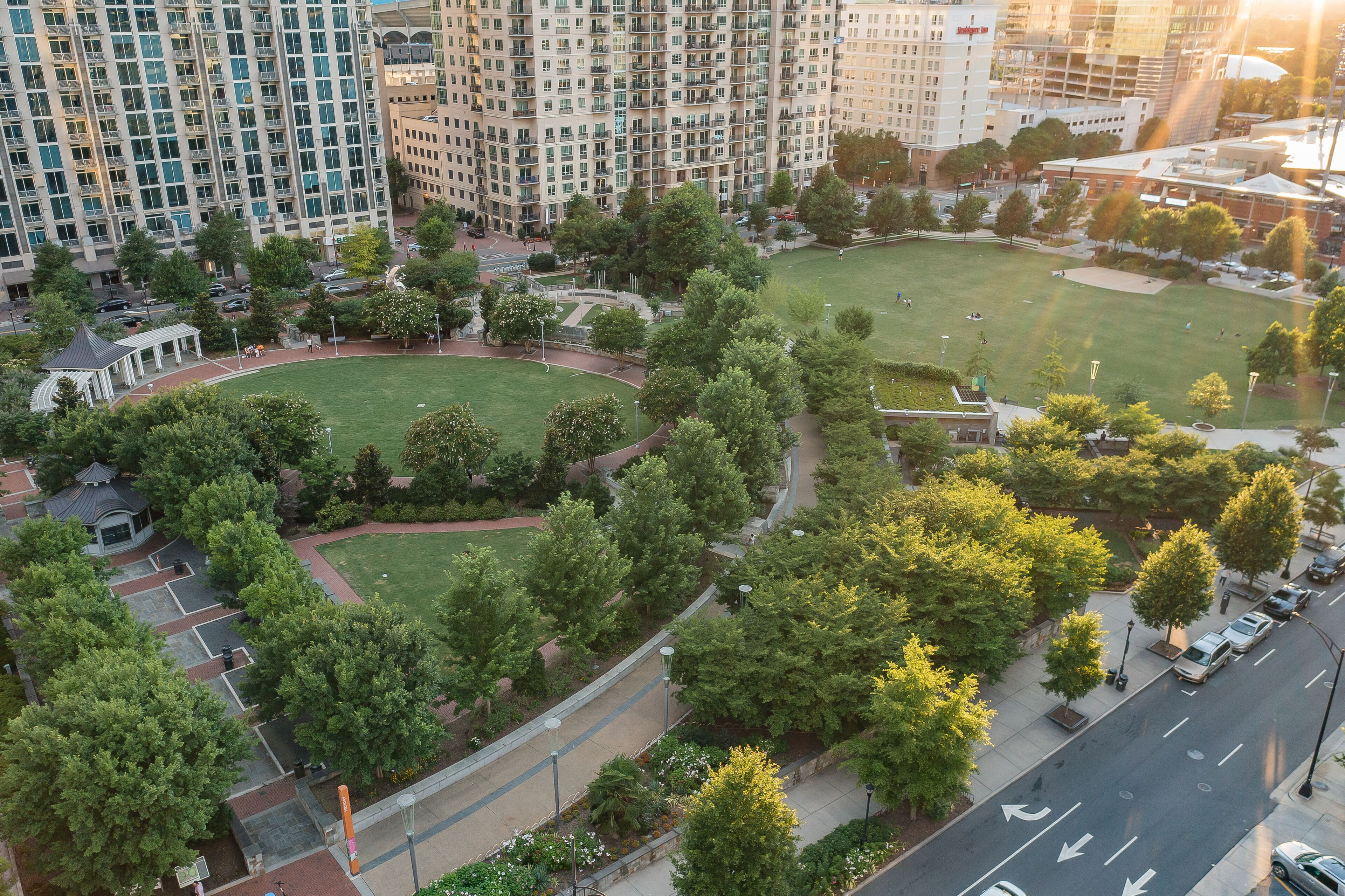 An aerial view of a residential area with multiple apartment buildings, green spaces, and a park.