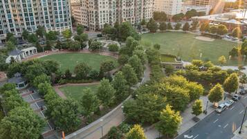 An aerial view of a residential area with multiple apartment buildings, green spaces, and a park.