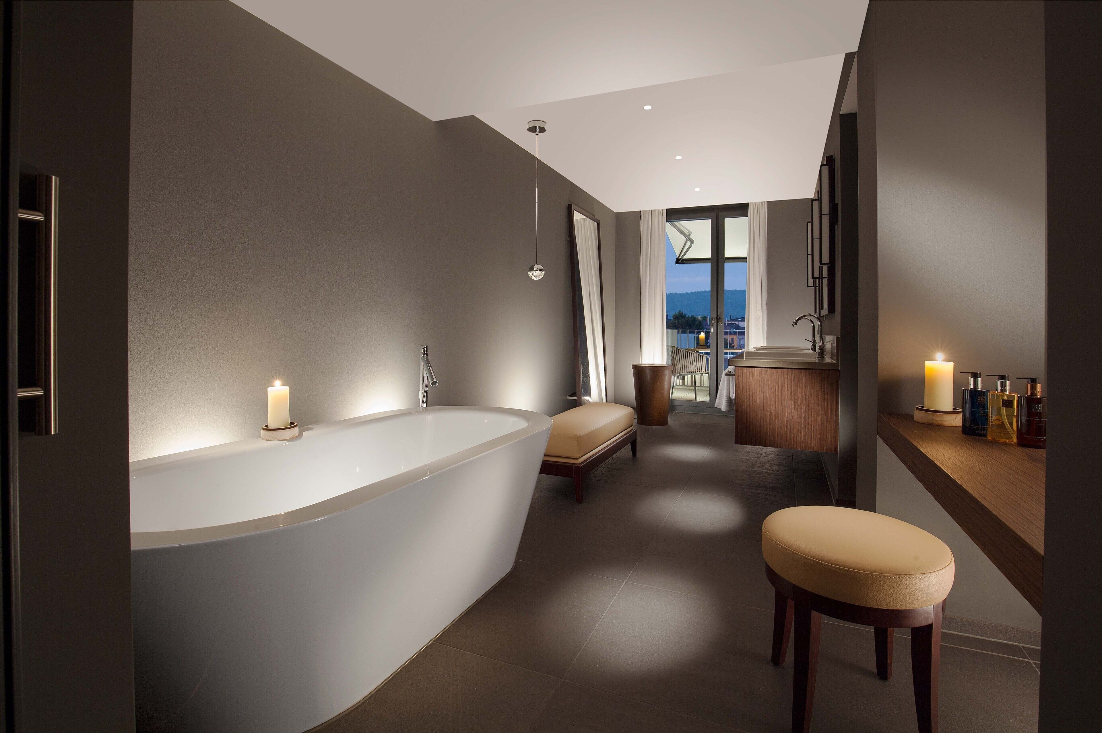 designer toiletries, hair dryer, slippers, towels