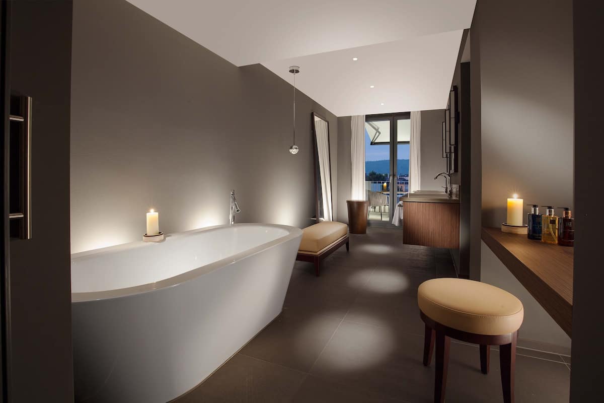 designer toiletries, hair dryer, slippers, towels