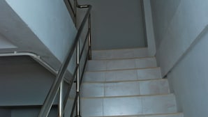 A staircase with metal railings and white tiled steps.