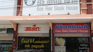 A multi-story building with a sign for Kee Ree Steak House.