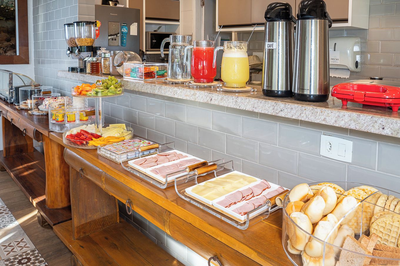 A buffet setup with various food items and beverages.