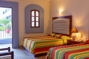 A hotel room with two beds, a window, a lamp, and a telephone on the nightstand. - Hotel Santa Helena Plaza (Oaxaca)