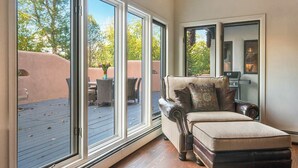 A cozy living room with a large sliding glass door leading to an outdoor patio area. - Luxury Home, Perfect Location, Flexible Layout (Santa Fe)