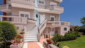 A multi-story building with a central staircase, balconies, and a well-maintained garden. - Private 4-Bedroom villa, large pool, amazing gardens, relaxing family vacations (Chania)