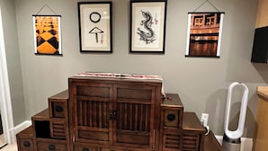 A wooden cabinet with multiple drawers and a television mounted on the wall above it. - A Cozy-kept Secret  Studio Located In The Heart Of 14/u St/logan Corridors (Washington)
