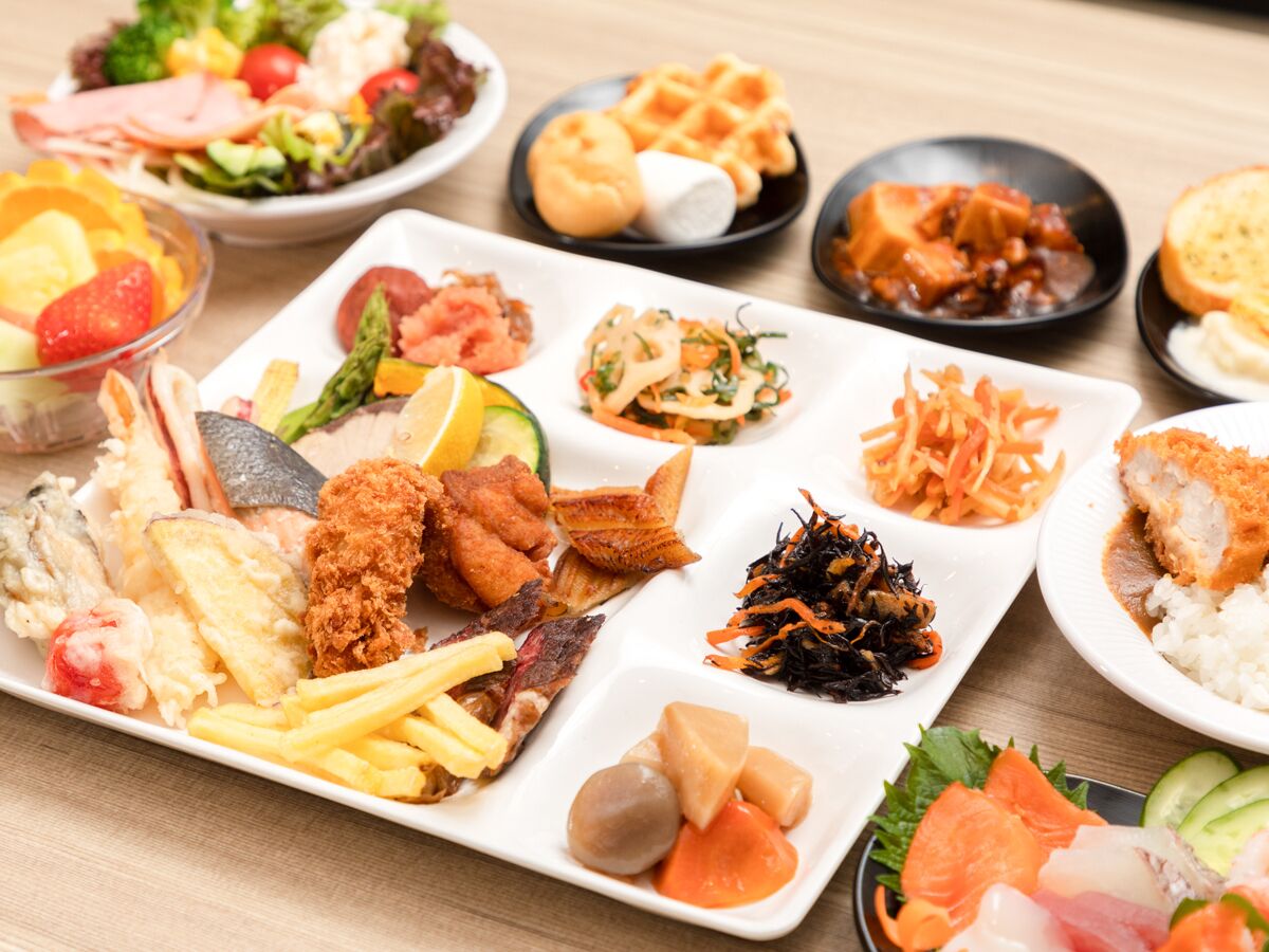 A variety of dishes including seafood, fried items, and salads on a table.