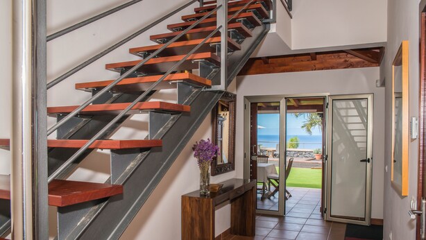 A staircase with wooden steps and metal railings, leading to a balcony with a view of the sea. - Casa Tagoro, facing the Ocean.  (Tacoronte)