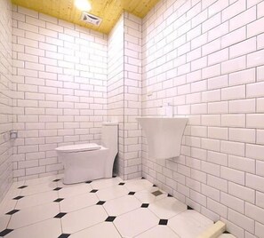 A small, white-tiled bathroom with a toilet and a sink. - Urban (Kaohsiung)