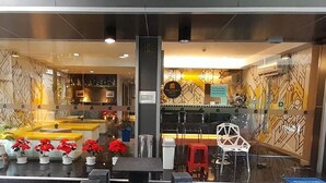 A modern hotel lobby with a reception desk, seating area, and decorative plants. - Collection O Pratunam 19 Hotel (Bangkok)