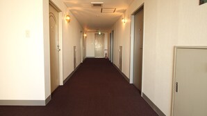 A long, narrow hallway with doors on both sides, leading to individual rooms. - Hotel LC Gifu-Hashima (Hashima)