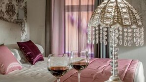 A neatly arranged bedroom with a bed, two bedside tables, and a decorative lamp. - Rome Visits (Rome)