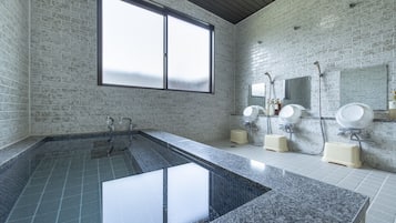 Bathroom features a large tub, two sinks, and a sleek design with white and gray tiles.