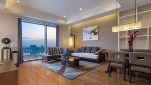 Un salon moderne avec une grande fenêtre, un canapé, une table basse et un coin repas.