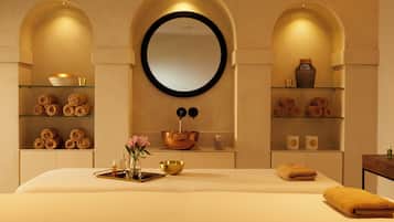 Experience a serene retreat with a large bed, minimalist design, and elegant arches.