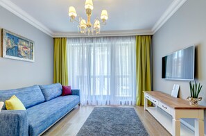 Apartment, 1 Bedroom, Balcony | Living room | Flat-screen TV
