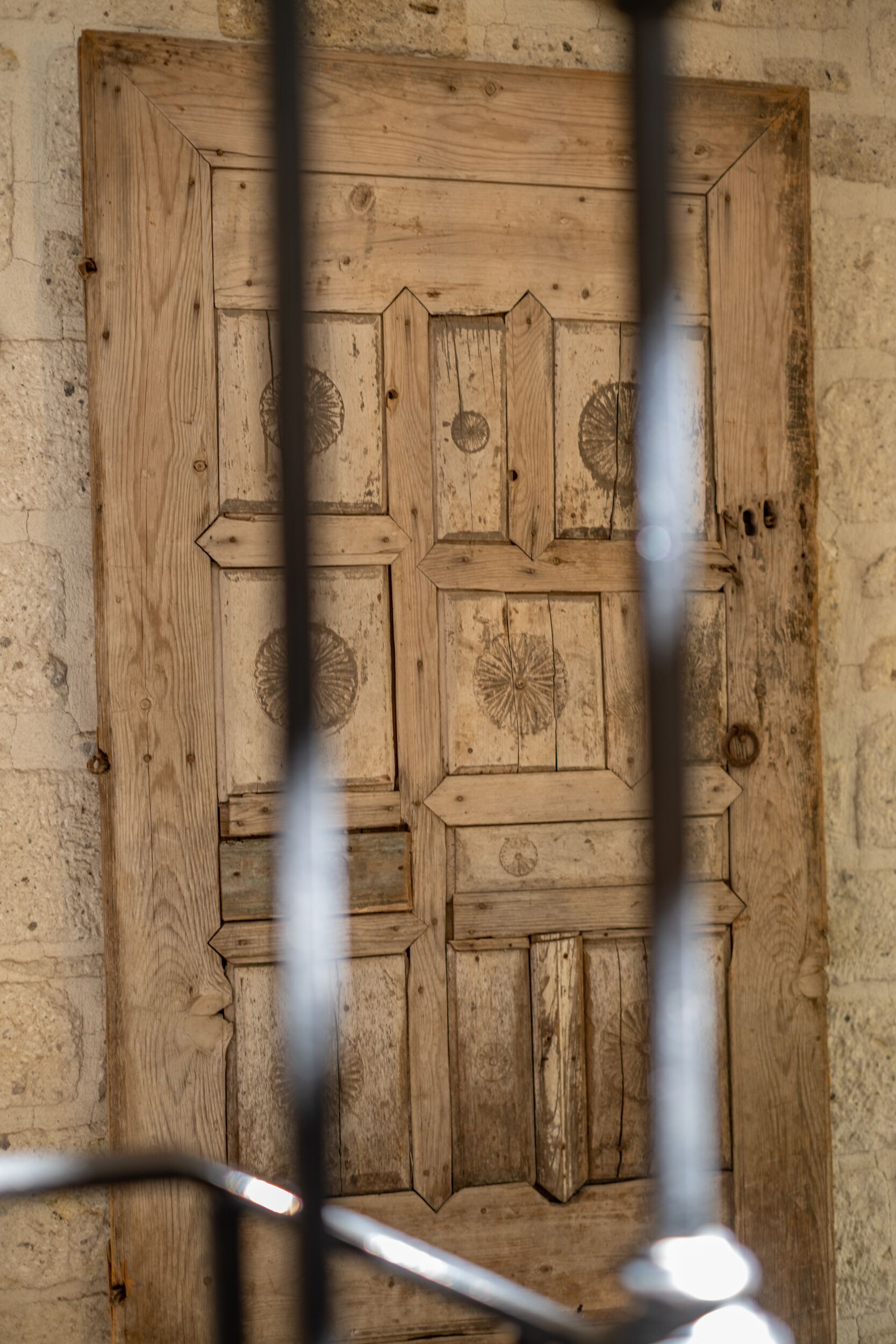 A wooden door with intricate carvings and a rustic appearance.