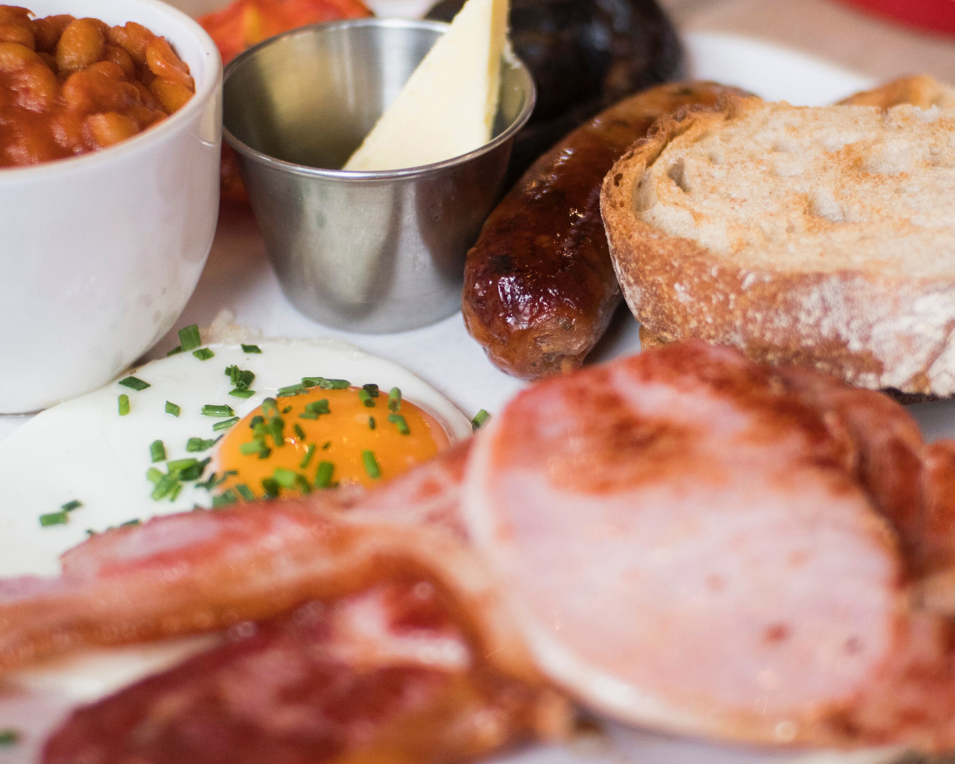 A plate with various breakfast items including eggs, sausages, and toast.