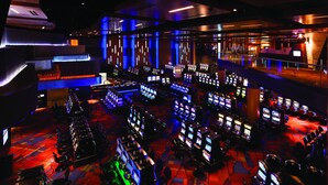 A large, modern gaming area with multiple gaming stations and a vibrant, colorful floor design. - Panther Creek Cabins (Cherokee)