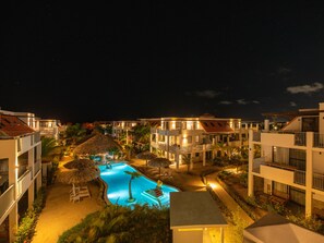 A resort with a swimming pool, multiple buildings, and a night sky. - Resort Bonaire (Kralendijk)