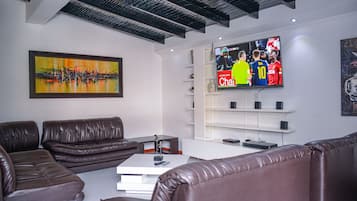 Superior Apartment, 6 Bedrooms | Living area | 32-inch flat-screen TV with cable channels, TV, DVD player