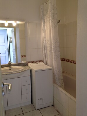 Bathtub, hair dryer, soap, shampoo
