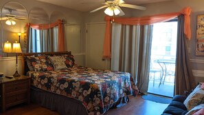 The beach is calling from the relaxing side balcony just beyond the bed.