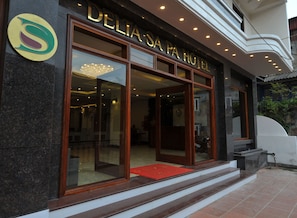 The exterior of DELIA'S PA HOTEL with a prominent entrance, a red carpet, and a modern design. - Sapa Delta Hotel (Sa Pa)