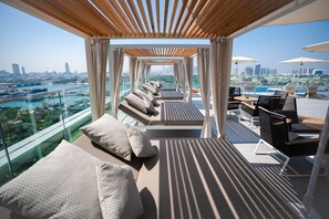 Outdoor pool, open 6:00 AM to 10:00 PM, free cabanas, pool umbrellas