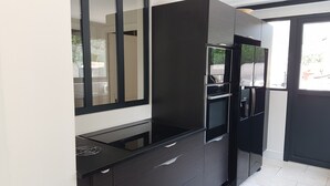 A modern kitchen with a black countertop, a built-in oven, and a large mirror. - Mas Mougins, near Cannes, very bright with quality fittings (Mougins)