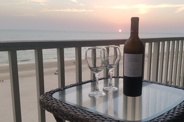 Enjoy a glass of wine on the balcony at Sunset.
