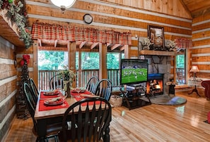 Dining area features large windows, hardwood floors, and open floorplan.