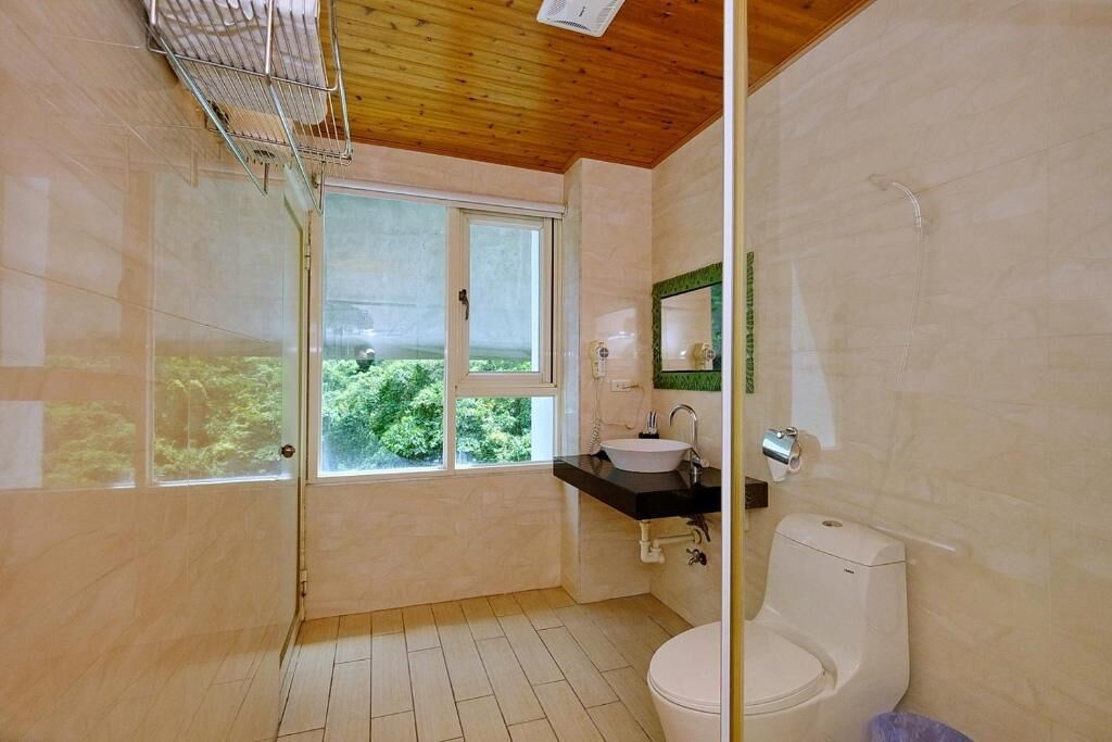 Een badkamer met toilet, wastafel en douche.