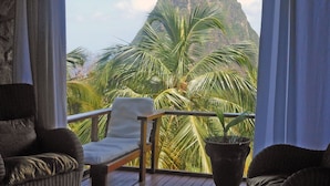A covered outdoor seating area with a view of a mountain.
