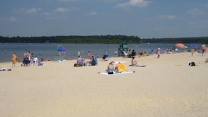 A beach with people sunbathing and swimming. - Luxury, Hot Tub,Fireplace,Pool Table,Pet Friendly,No Security Deposit! (Albrightsville)