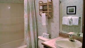 A bathroom with a bathtub, toilet, and sink. - Oceanfront 3rd floor, Balcony with Spectacular Ocean Views (Seaside)