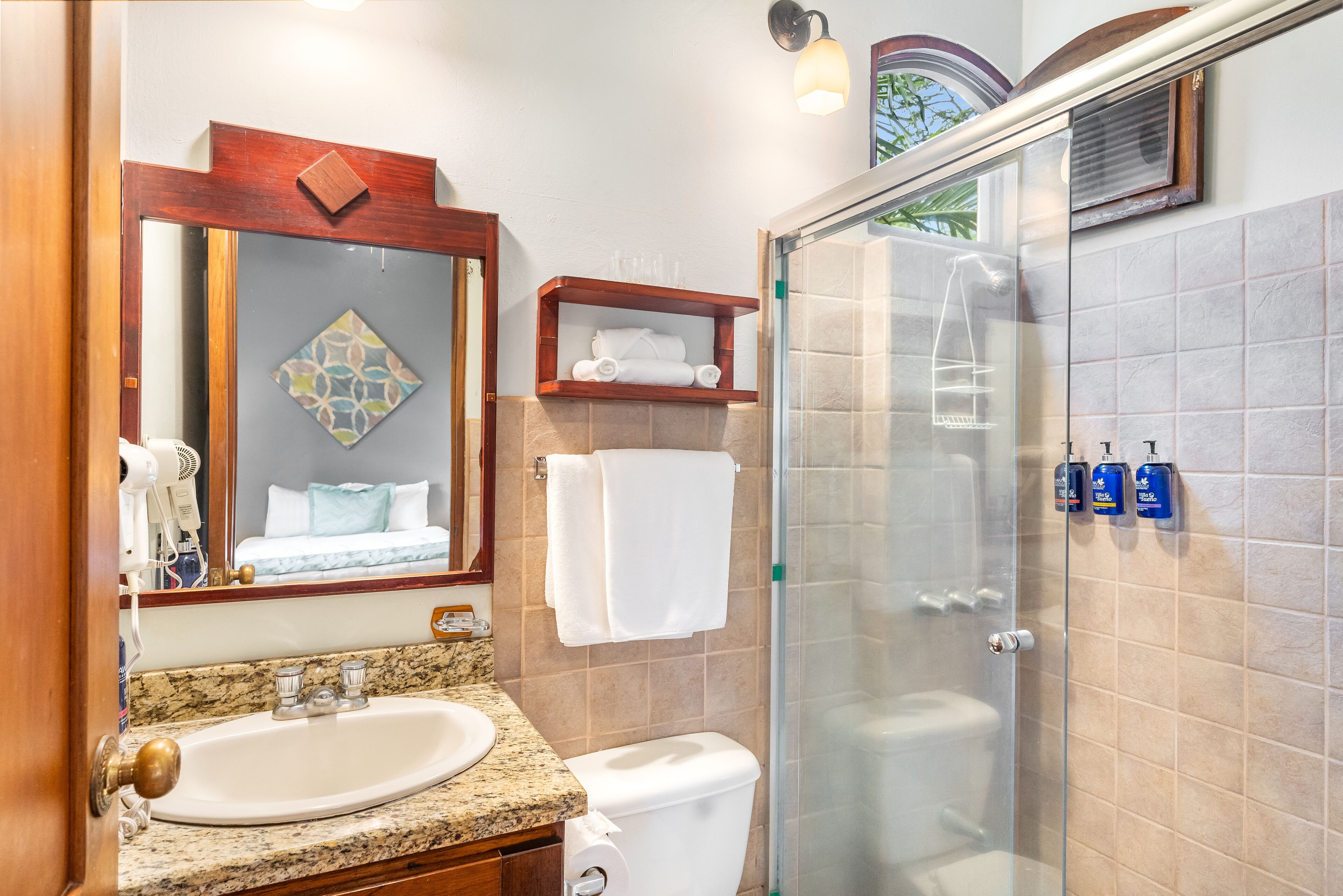 A bathroom with a sink, toilet, and shower.
