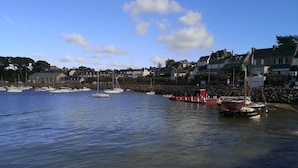 A harbor with boats, a red dock, and houses in the background. - Sea view, comfortable house in Loguivy-de-la-Mer, near Paimpol  (Ploubazlanec)