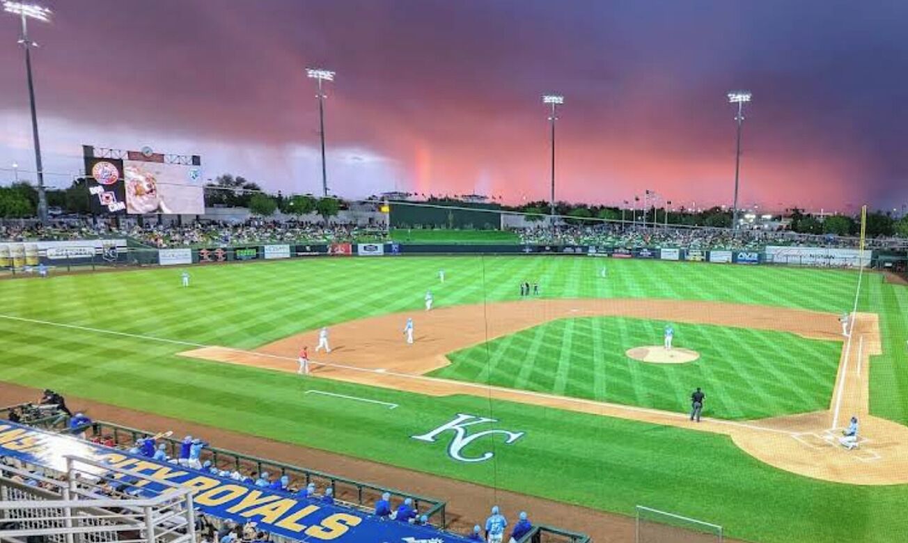 A baseball stadium with a clear view of the field, seating, and a scoreboard.